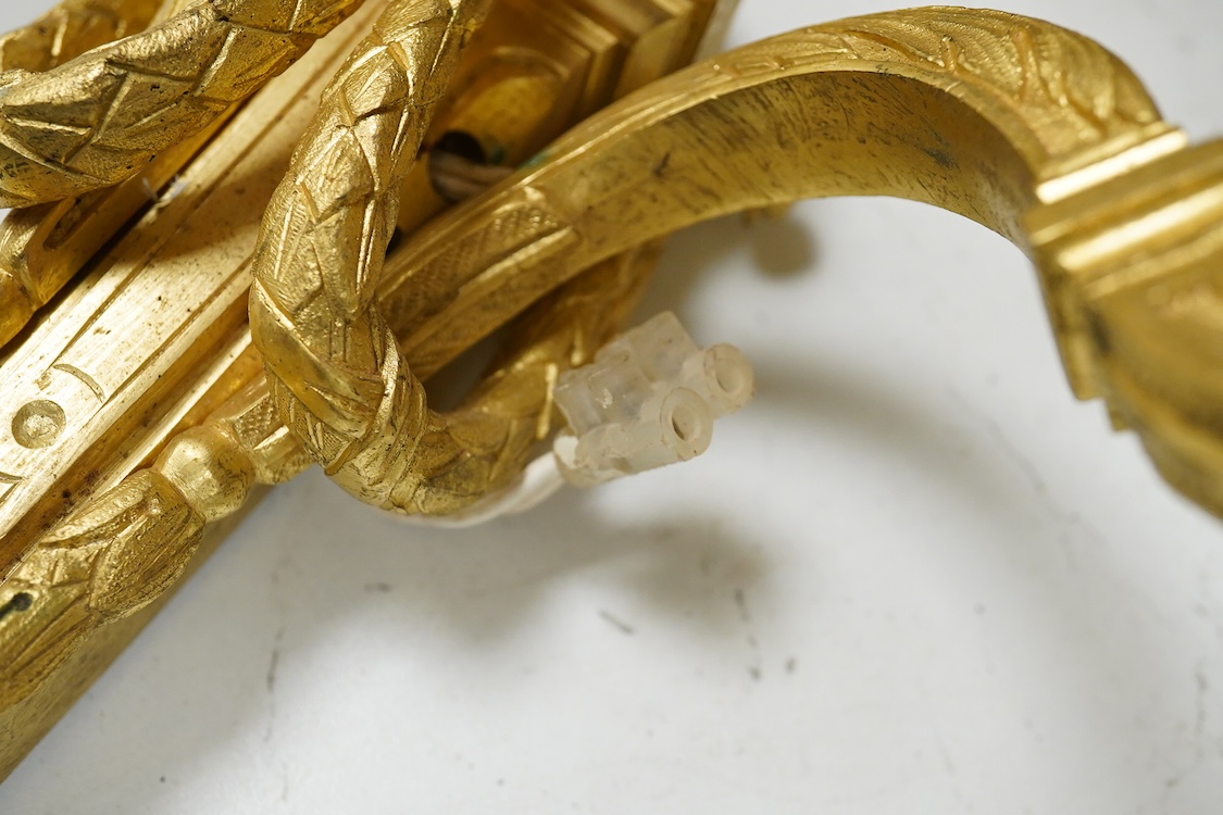 A pair of Adam style cast brass three branch wall sconces - 36cm high, with similar two branch sconce